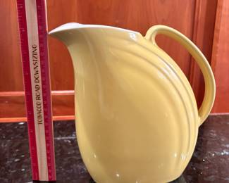 T4 - $20. Hall pottery pitcher in yellow. Measures 8.5" x 8" tall. Excellent condition.