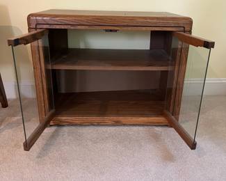T47 - $10. Wood cabinet with glass doors and 1 adjustable shelf. Measures 28.5" x 16.5" x 22" tall. Good condition, but back needs to be reattached.