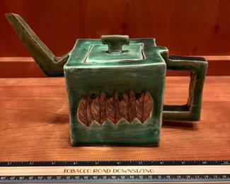 T29 - $25. Unsigned Pottery Teapot with Leaf Design. Measures 10" x 6.25" tall. Excellent condition.