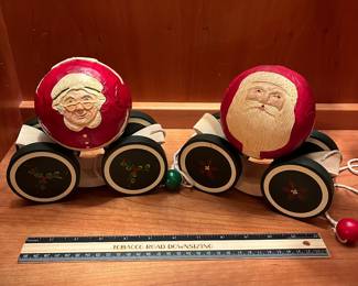 T123 - $120. Pair of Vintage Christmas 1988 BRIERE Mrs. Claus and 1986 Santa Folk Art Pull Toys. Each measures 7.25” x 6.5“ tall.