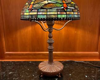 T5 - $125. Quoizel Table Lamp, Tiffany style shade with damage as shown in photo, Dragonfly motif. 18.5" tall.
