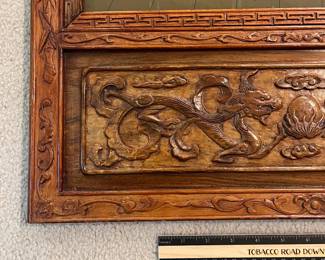 T93 - $750. PAIR of Chinese Ancestor Reverse Paintings on glass with intricately carved wood frame and brass hanging plates. Each Measures 21.75" x 41.5"T. Very good condition.