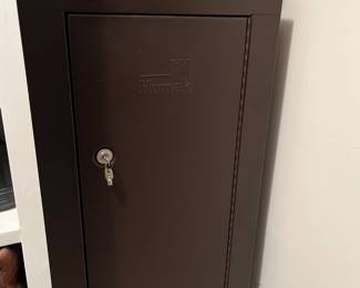 T114 - $150. Homak Keyed Metal Gun Safe. Measures 21" x 10" x 55" tall. Excellent condition.