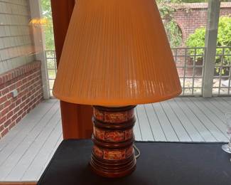 T57 - $60. Asian Style Wood and Porcelain Lamp. Lamp is in good condition and the shade shows signs of age. Measures 29” tall.