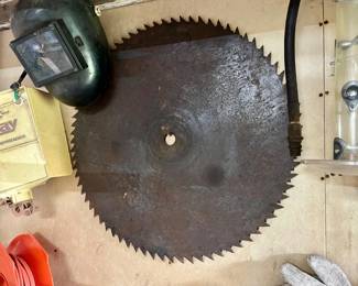 two buzz saw blades. only largest showing