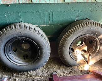 Four large truck tires and rims