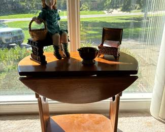 Vintage side table with attached leaves.