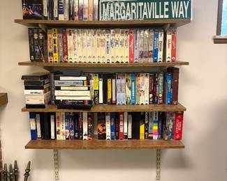 Selection of VHS and DVD collection. Margaritaville sign