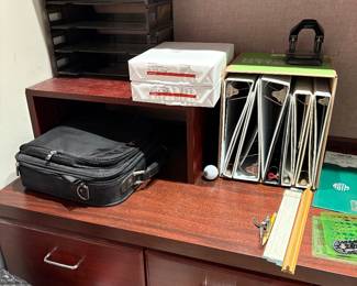 Binders, paper and a soft briefcase computer bag