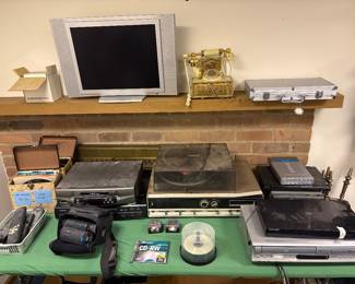 Vintage electronics including VHS player, DVD players, vintage Lloyd's record player and a camcorder