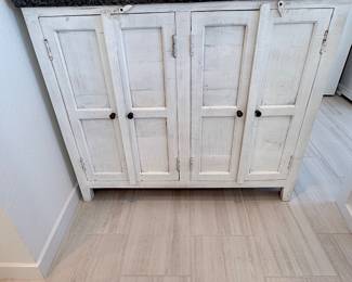 Distressed white 4-door accent/storage cabinet. $325
