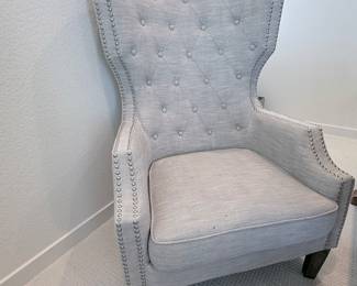 Light gray tufted armchair with nailhead trim. $160