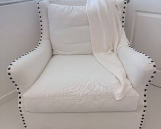 Designer upholstered accent chair in neutral linen with nailhead trim. $250