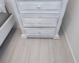 Distressed white 3-drawer nightstand — matches the coastal farmhouse collection. $95