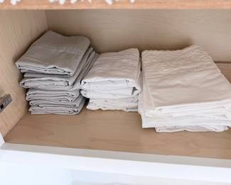 Folded sheet sets — part of the neutral bedding/towel bundle. $75 takes the bundle