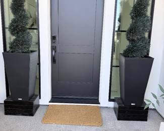 Front-entry set — 2 black planters with spiral topiaries + woven doormat. $160 for the set