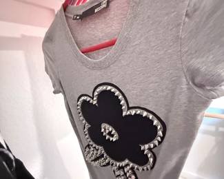 Part of the 75+ piece clothing bundle (gray floral graphic tee shown). $175 for all
