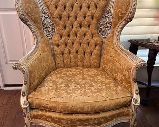 antique high back wingback chair with musical instrument crest