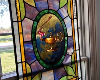 vintage stained glass panel with central oil lamp