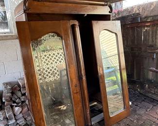 Available for pre-sale!! Vintage Mirrored Wardrobe / Armoire – Restoration Project.  Large vintage wood wardrobe featuring two full-length mirrored doors, decorative column details, substantial molded cornice and rolling pedestal base. Currently disassembled and in need of reassembly and refinishing. Components and base included. 