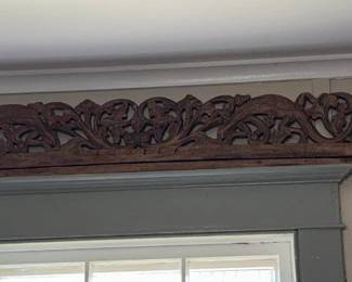 Large hand-carved wood decorative panel featuring geckos hidden among scrolling vines and foliage. Approximately 6 feet long.