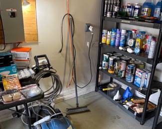 Power washer, pushbroom, variety of paints, paint, supplies, Lysol, air, freshener, caulking, and windshield washer fluid.