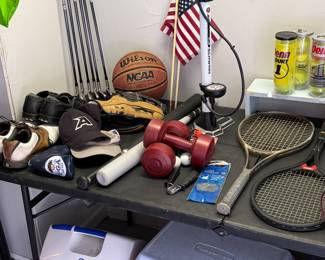 Tennis rackets and balls, dumbbells, golf, clubs, and coolers.