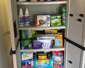 Cleaning products, Bissell shampoo, swifter refills and storage cabinet.