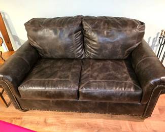 Faux leather studded loveseat in excellent condition! 70"w x 41"d. $300