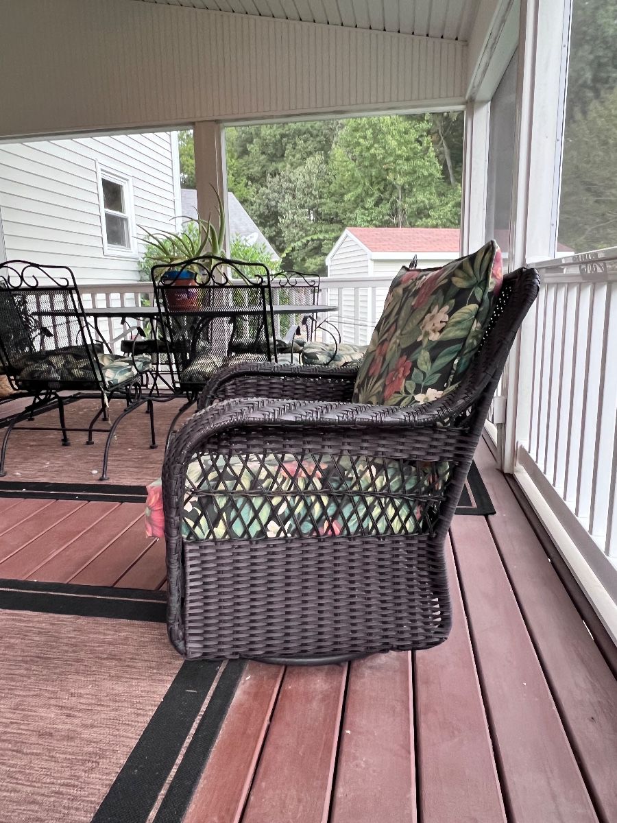 Cushioned outdoor chairs on a porch at a Chesapeake estate sale