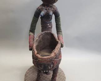 Lot 218  Vintage African beaded figural sculpture holding