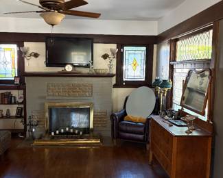 Furniture, brass fireplace fender, stained glass, sconces and armchair are not for sale 