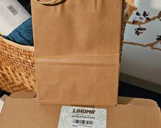 Brown Kraft paper gift bags with twisted paper handles.