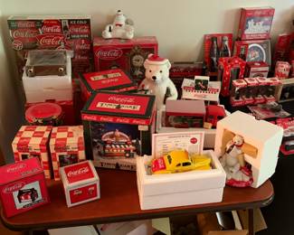 Vintage Coca-Cola collectibles including polar bear cookie jar, Town Square Collection Polar Palace, Danbury Mint 1940 Ford Coupe with certificate, polar bear figurine, delivery truck, drinkware and perpetual calendars