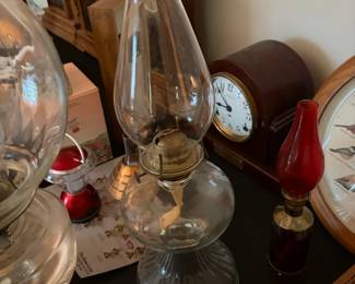 Antique glass oil lamps with vintage clocks