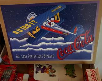 Coca-Cola collectible with vintage airplane artwork