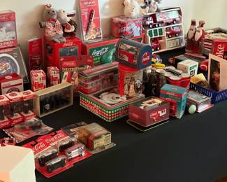 Coca-Cola memorabilia including Sunset Diner tin, mailbox tin, collectible tins, miniature bottle sets, die-cast cars, Matchbox, light-up pen, plush and Pepsi-Cola clock