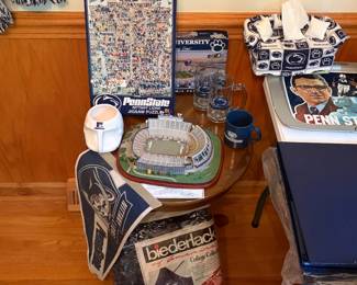 Penn State memorabilia with Beaver Stadium replica, mugs and tissue box cover
