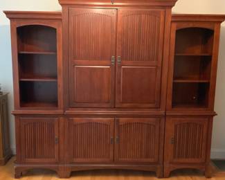Three section entertainment unit. Good flat screen TV. Side cabinets 23 3/4” W x 18 1/2” D x 74” H. Center cabinet 50 1/16” W x 22 1/2” D x 80” H. 