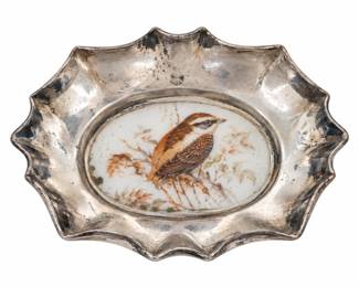 Small scalloped silver-tone dish with a bird illustration.