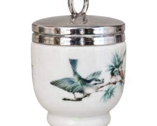 White bird-decorated jar with a silver-tone lid and loop handle.