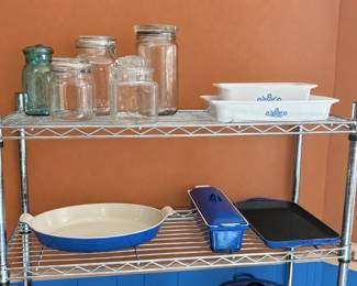 KITCHEN ◆ BAKEWARE & STORAGE  Glass storage jars with lids ◆ White baking dishes with blue floral designs ◆ Blue oval baking dish ◆ Blue lidded casserole ◆ Blue rectangular grill pan ◆ Chrome wire shelving.