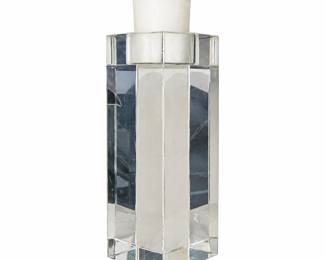 Tall clear geometric candle holder with a white candle.
