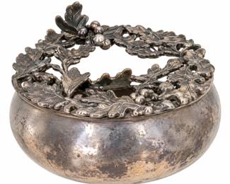 Silver-tone decorative bowl with an openwork leaf-and-berry top.