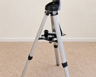 Bushnell telescope with tripod, accessory tray, and eyepieces.
