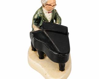 Miniature pianist figurine with a black grand piano