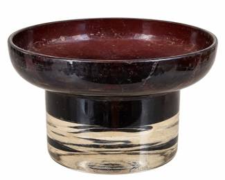 Wide burgundy pedestal bowl with a cream-and-black patterned base and visible surface wear.