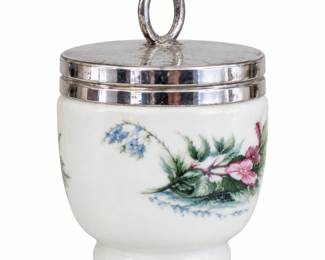 White floral jar with a silver-tone lid and loop handle.