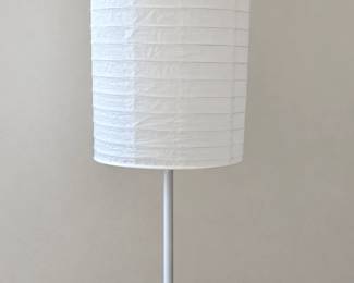 Slim white floor lamp with a cylindrical textured shade.
