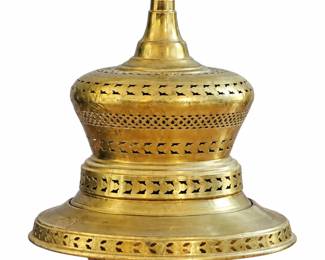 Brass-tone decorative vessel with pierced detailing, curved feet, and a figure finial.